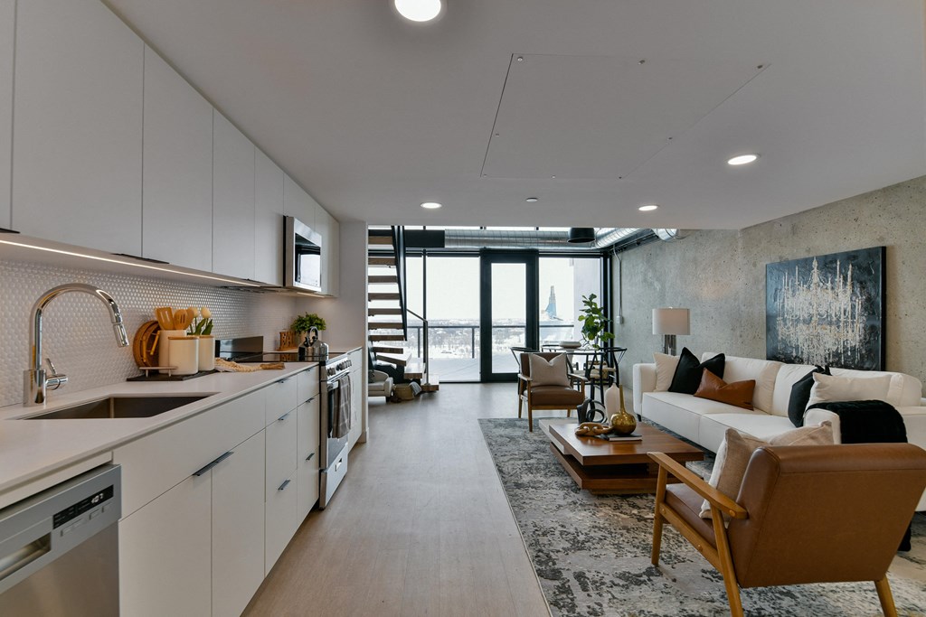 a kitchen and living room in an open floorplan apartment