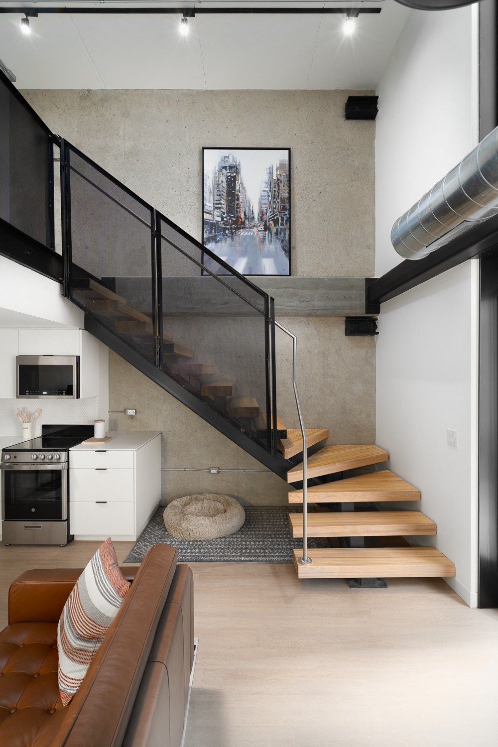 a staircase leading up to a living room with a couch and a television