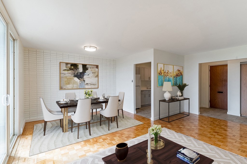 a living room and dining room with a table and chairs