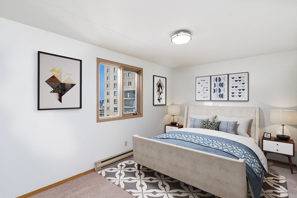 a bedroom with a bed and pictures on the wall