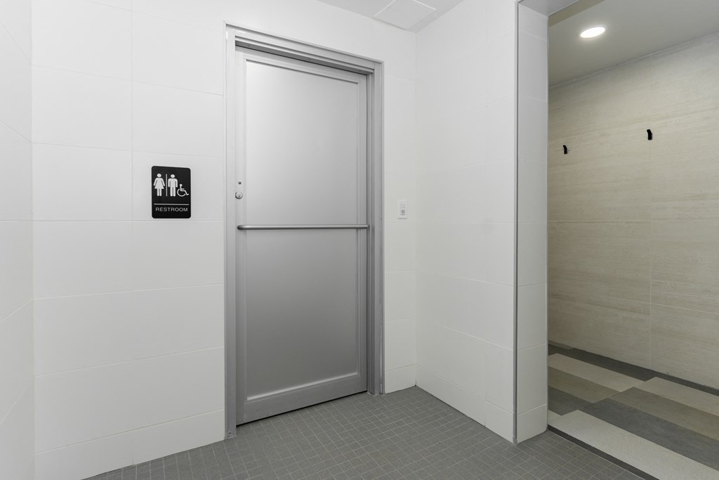 a white elevator with a door and a sign on the wall
