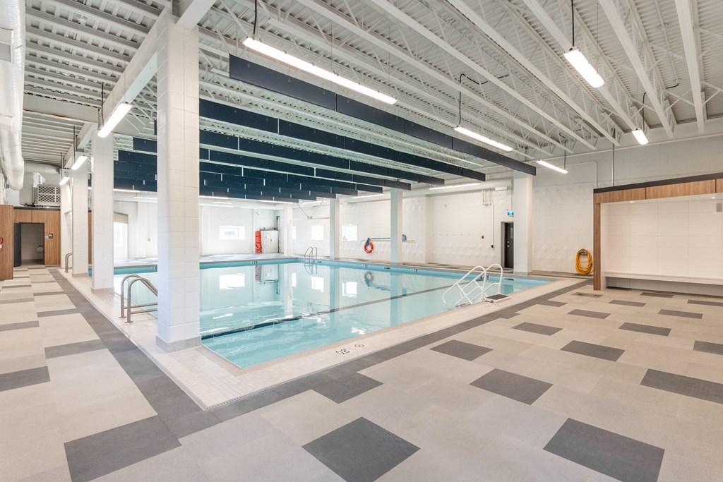 a large indoor swimming pool with a diving board