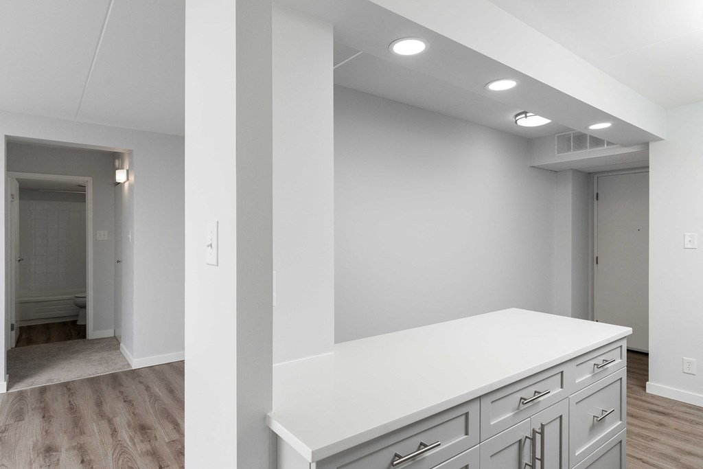 a kitchen in a bedroom plus den unit.