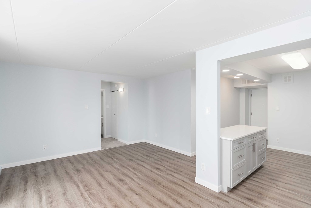 an empty bedroom with a vanity in the corner of the room