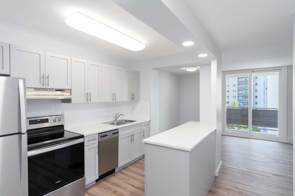 a kitchen with white cabinetry and black appliances