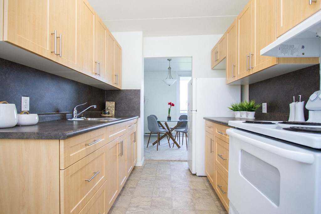 a kitchen with wooden cabinets and white appliances