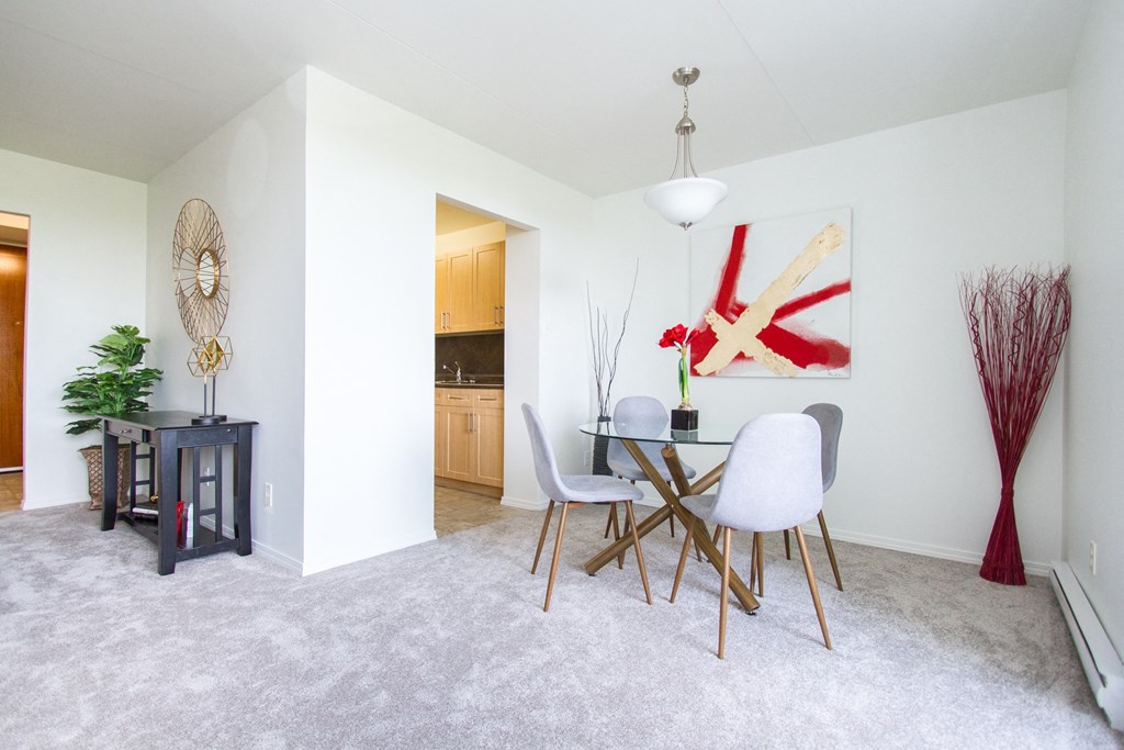 a dining room with a table and chairs