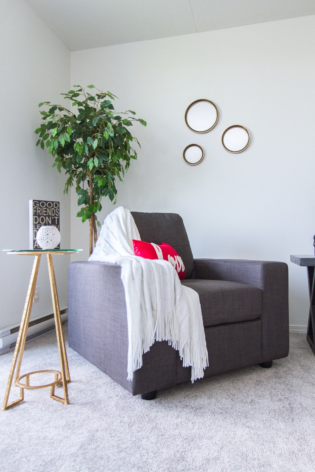a couch in a living room with a plant and two circles on the wall