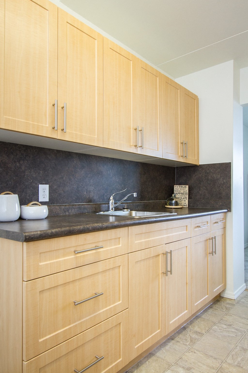 a kitchen with wooden cabinets and granite countertops