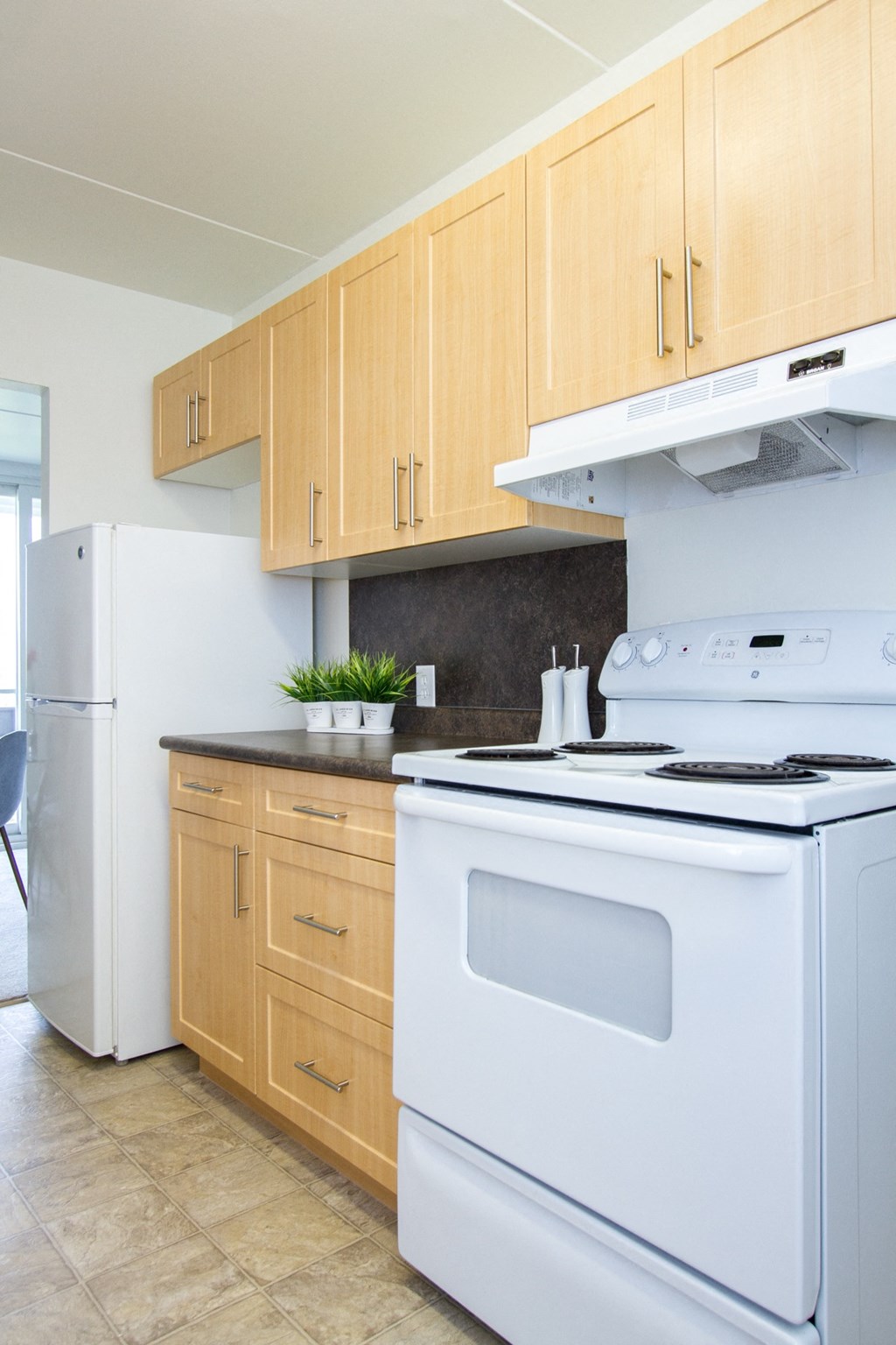 a kitchen with white appliances and wooden cabinets