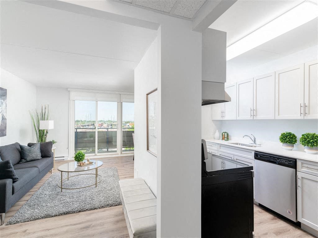 a living room with a couch and a kitchen