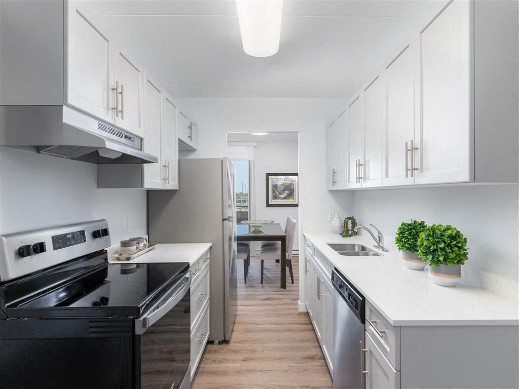a kitchen with white cabinets and a black stove
