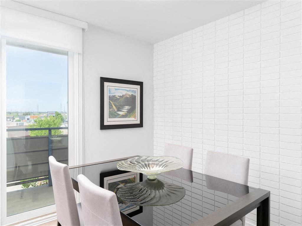 a dining room with a glass table and chairs