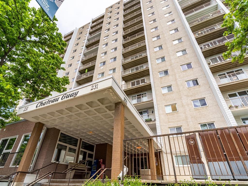an apartment building with a porch in front of a tall building