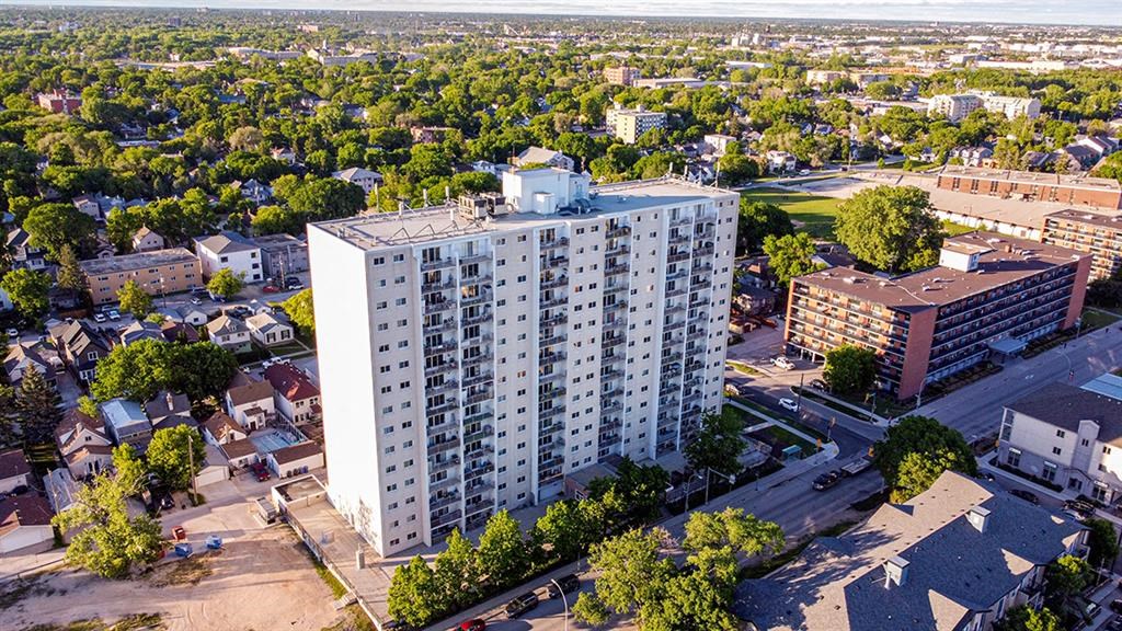 an aerial view of a tall building in a city