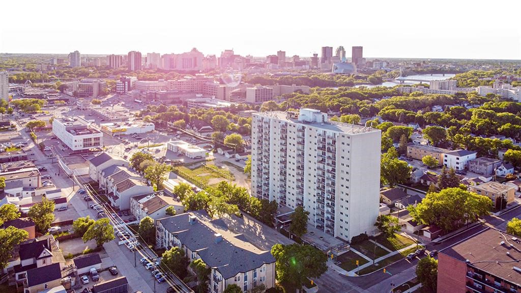 an aerial view of a city with a tall building