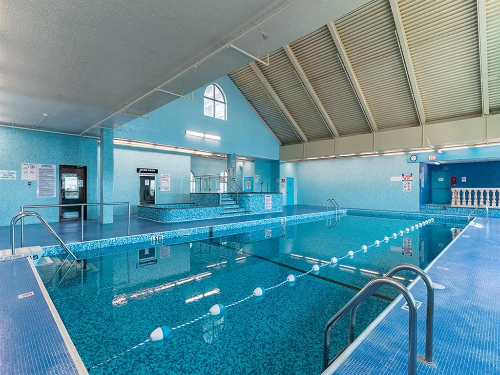 a swimming pool at a hotel with a blue walled pool