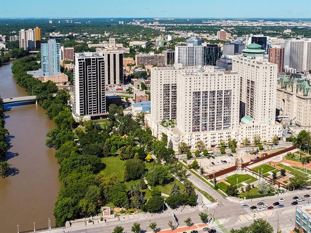 an aerial view of a city with a river and tall buildings