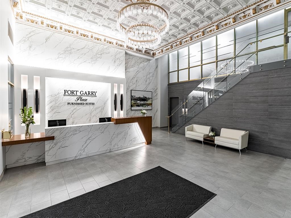 a rendering of a lobby with a reception desk and a staircase