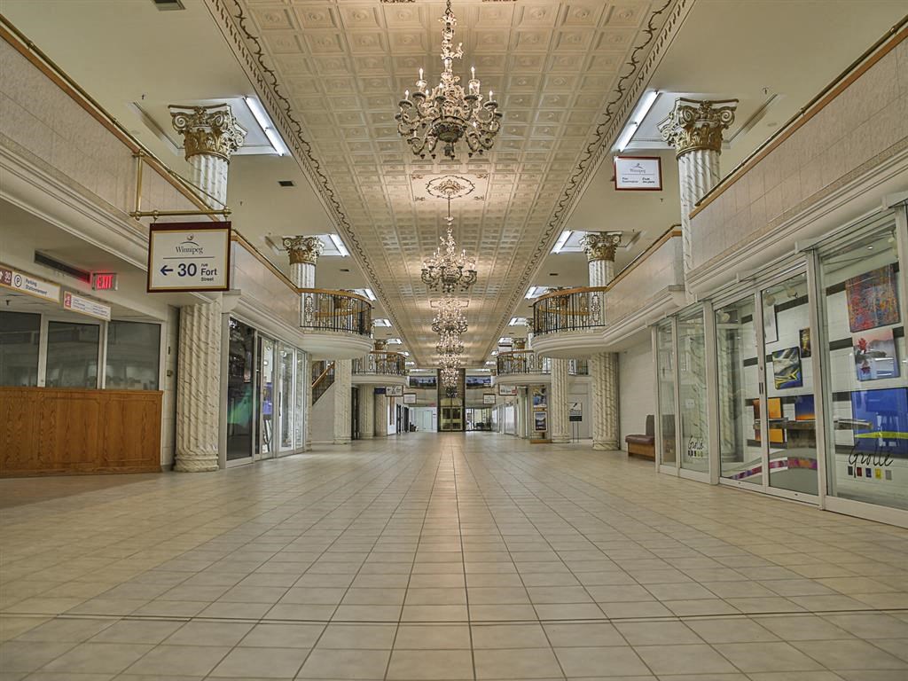 a large empty mall with chandeliers in the ceiling