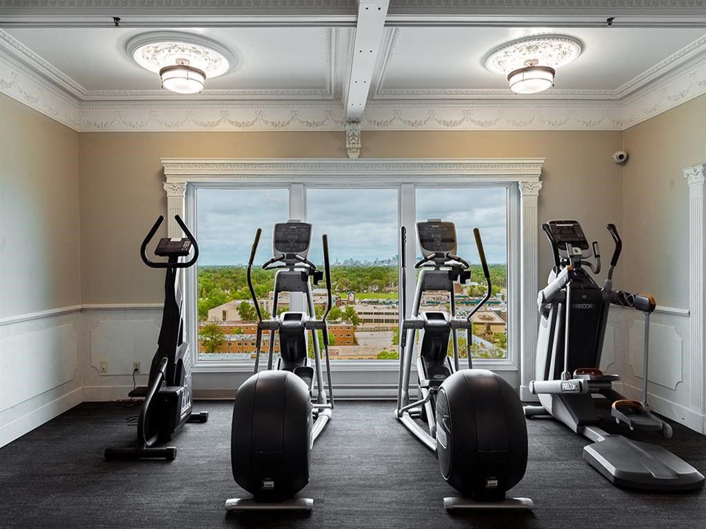 a gym with exercise equipment in front of a window