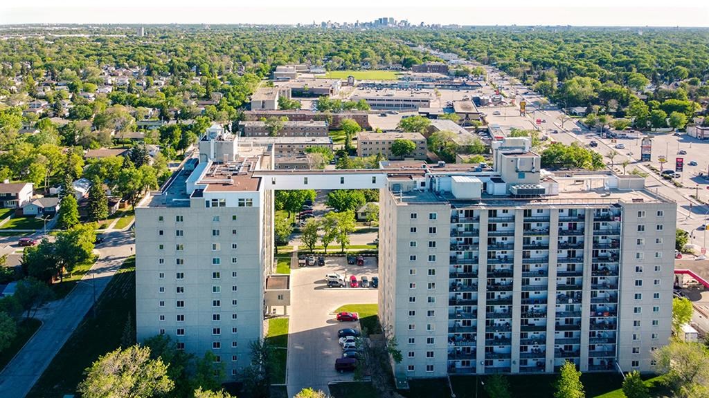 an aerial view of a large building with a city in the background