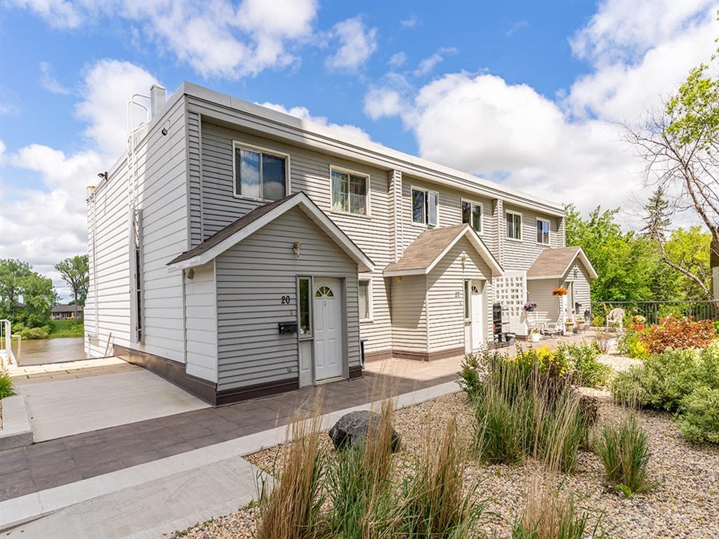 the front of a house with a porch and a sidewalk