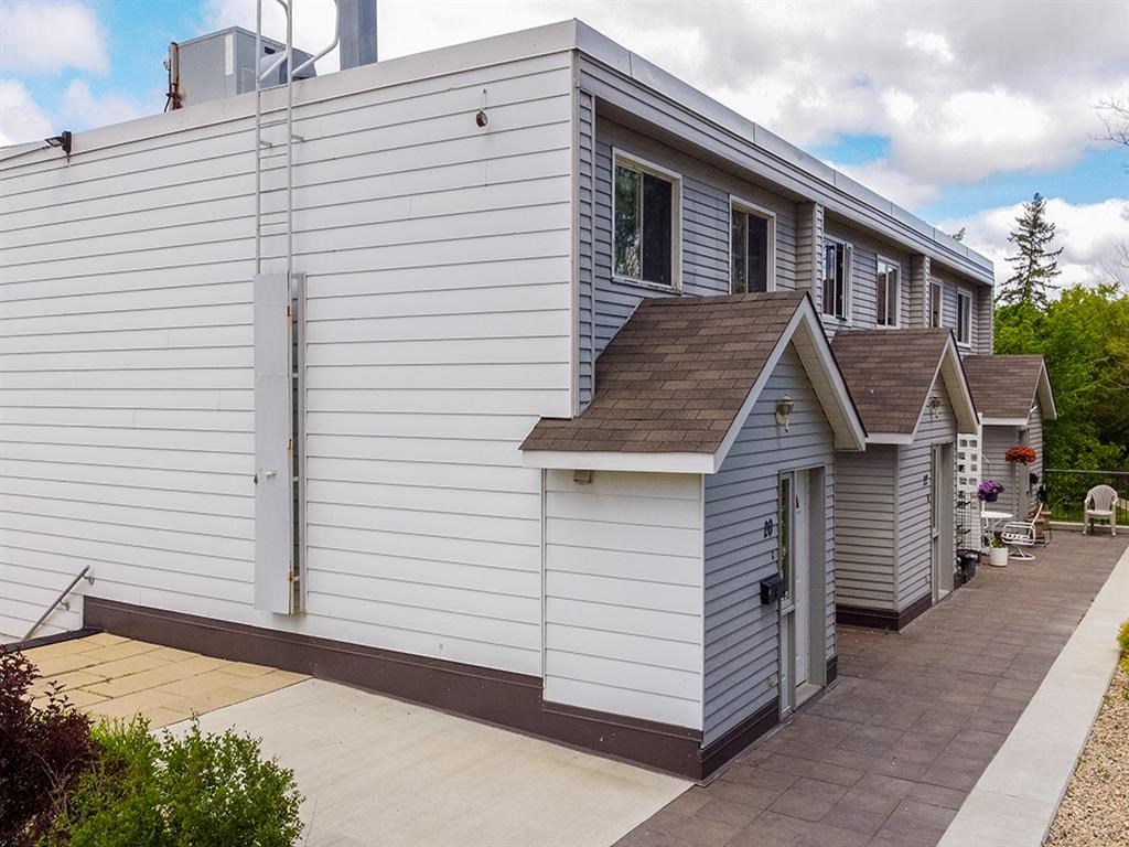 a white house with a garage and a porch