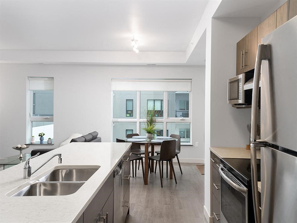 a kitchen and dining room with a sink and a window