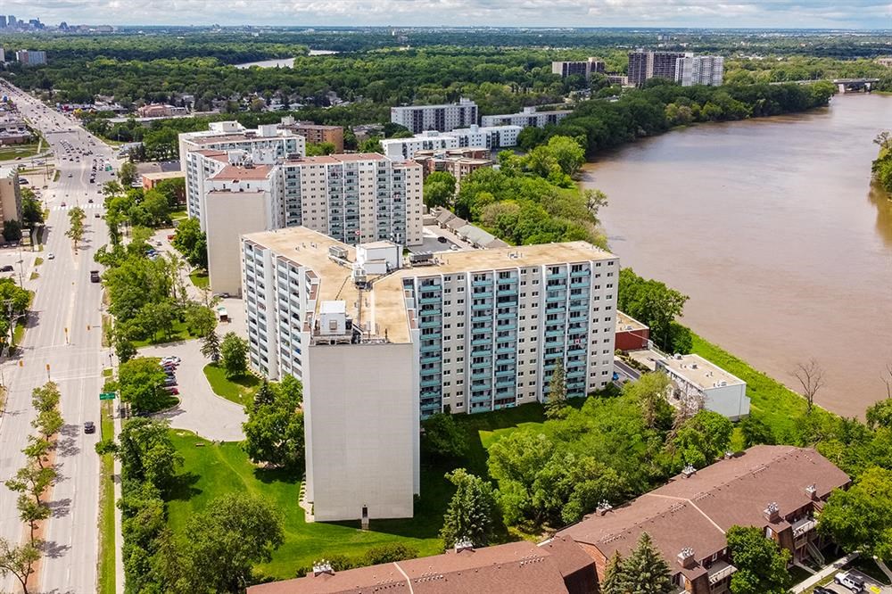 an aerial view of a building next to a river
