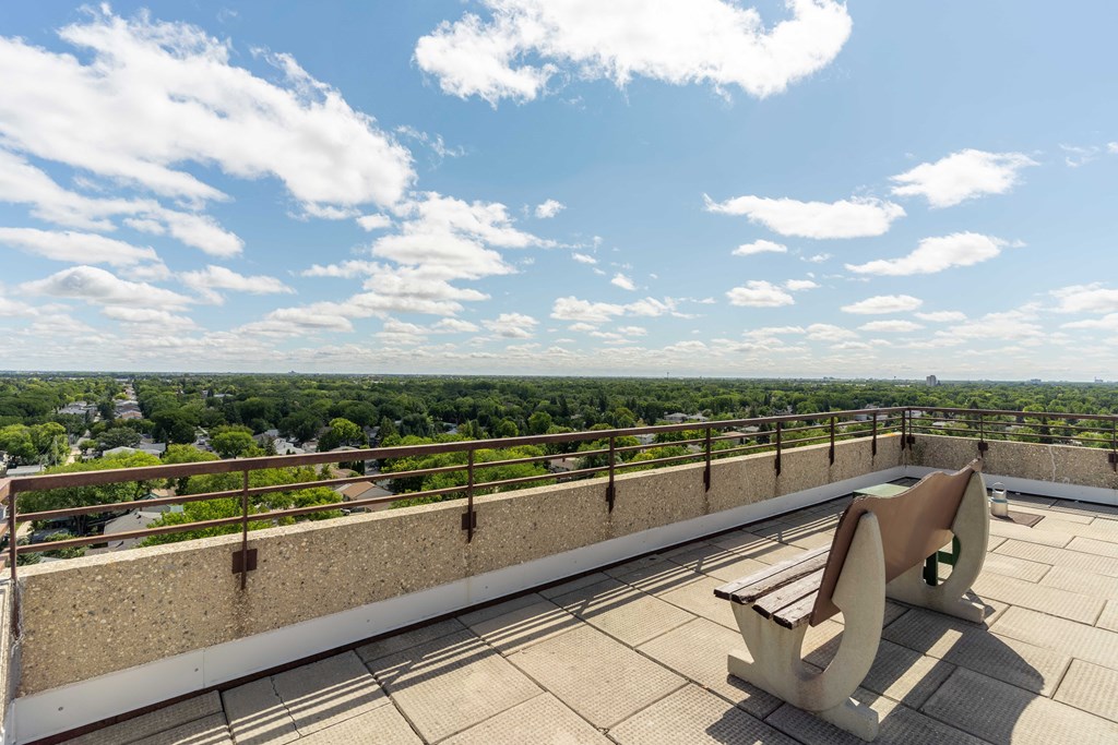 a bench on the roof of a building with a view of the city