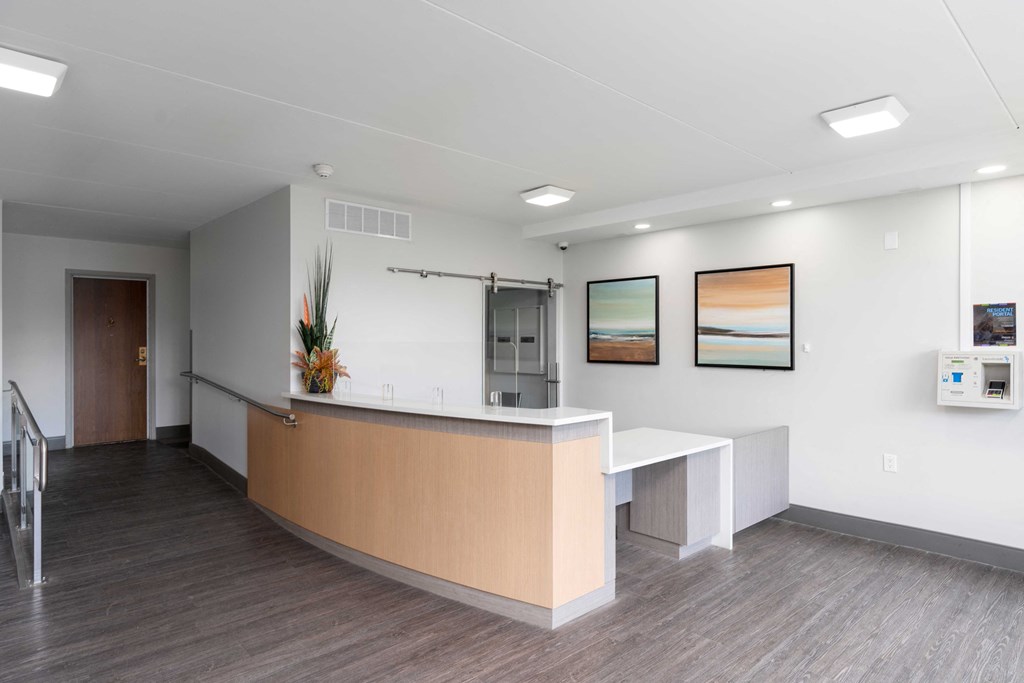 a reception area with a counter and chairs