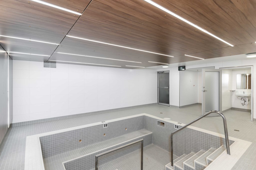 a large room with white walls and a wooden ceiling