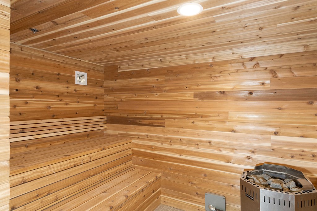 a large sauna with a wooden wall and floor
