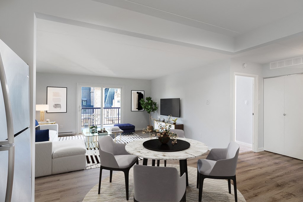 a living room and dining room with a table and chairs