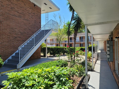 A staircase with a metal railing leads up to a building.
