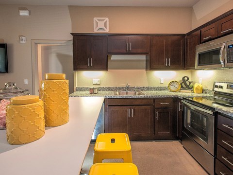 A kitchen with brown cabinets and a white counter.