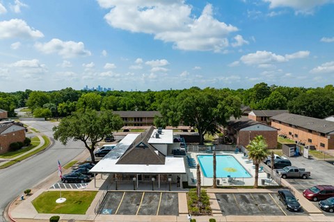 A large building with a pool in front of it.