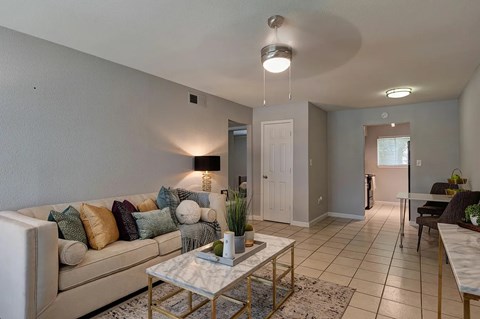 A living room with a white couch and a coffee table.