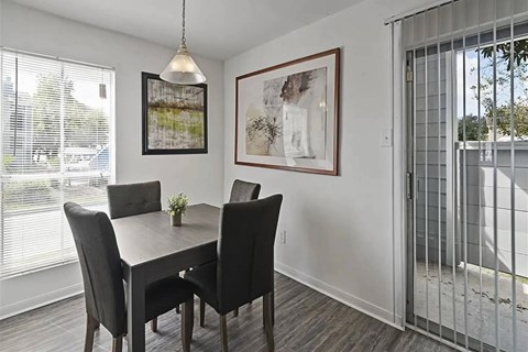 A dining room with a table and chairs.