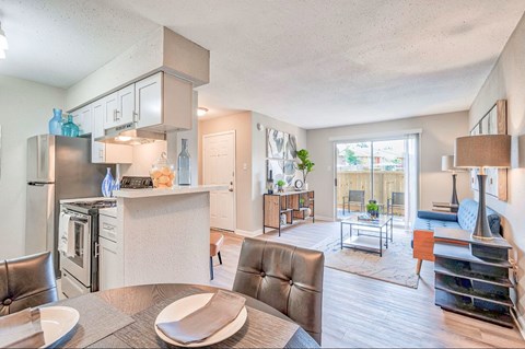 A modern kitchen with a dining table and chairs.