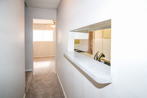 A small, empty room with a window and a sink.