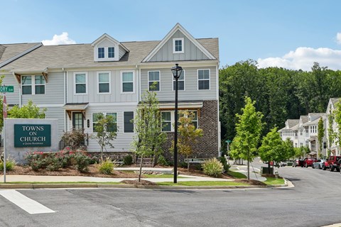 A grey building with a sign that says "Towns on Church".