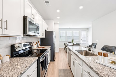 A kitchen with granite countertops and stainless steel appliances.