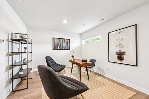A living room with a brown chair and a wooden table.