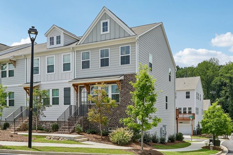 A grey house with a white door and windows.