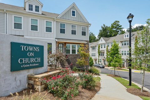 A sign that says "Towns on Church" is in front of a building.