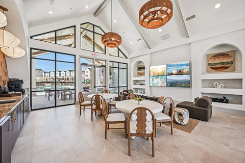 A modern dining room with a large table and chairs.