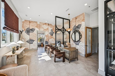 A modern living room with a large leaf-patterned wallpaper and a mix of wooden and glass furniture.