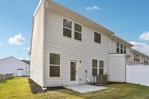 A house with a white exterior and a grey roof.